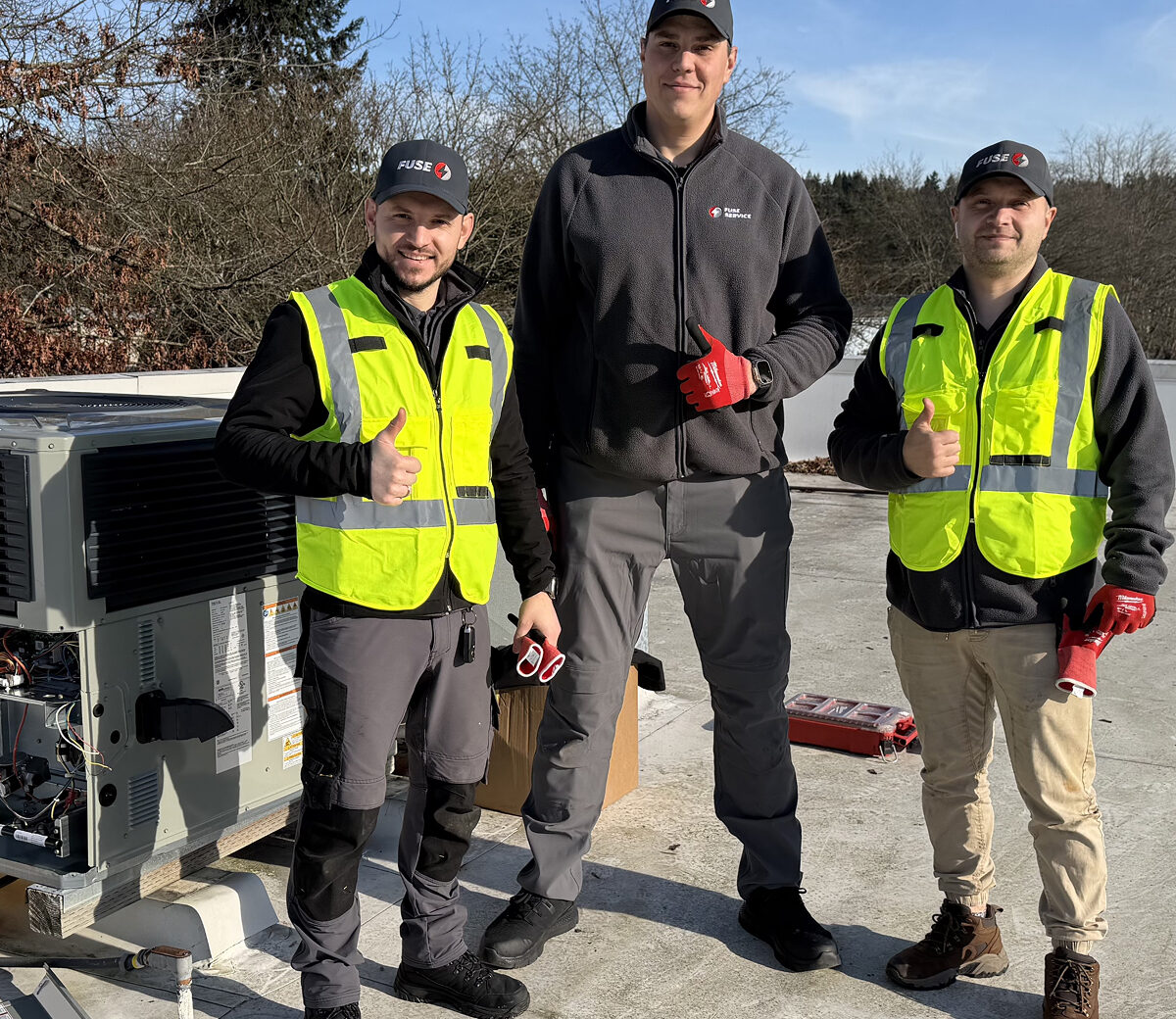 Technicians performing rooftop HVAC RTU replacement in Redmond.